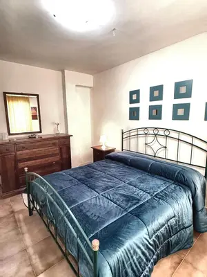a bedroom with a large bed and a dresser at Casa Alamar 100 metri dal mare in Alcamo