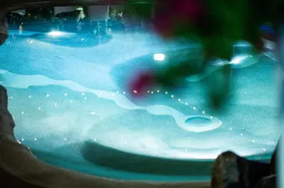 a person in a pool of water with a wave at RhelizeOne & Spa جميل in Palermo