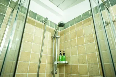 a bathroom with a shower with two bottles in it at RhelizeOne & Spa جميل in Palermo
