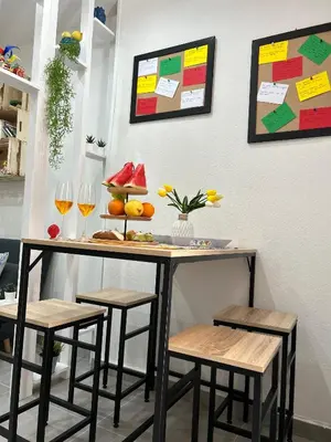 a table with stools and wine glasses on a wall at Casa Elivì Ballaró 2 passi dal centro storico, parcheggio e stazione ferroviaria in Palermo