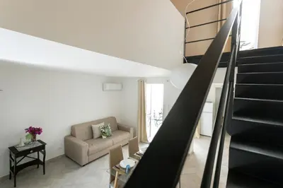 a living room with a staircase and a couch at RYS Mondello House in Palermo