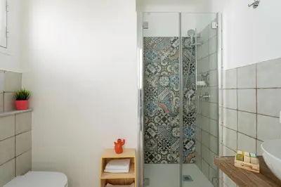 a bathroom with a shower and a toilet and a sink at RYS Mondello House in Palermo