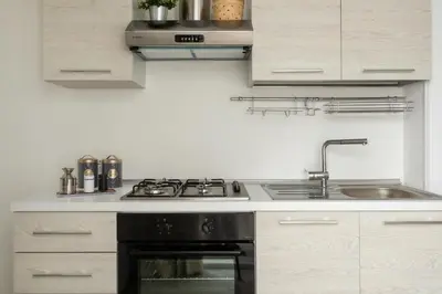 a kitchen with a stove and a sink at RYS Mondello House in Palermo