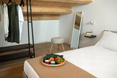 a basket of fruit on a bed in a bedroom at RYS Mondello House in Palermo