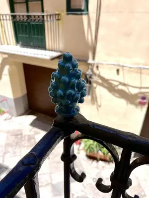 a blue object on top of a metal railing at Casina al 32 in Palermo