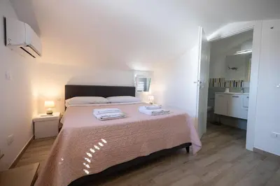 a bedroom with a large bed with two towels on it at Villa Giada - Private pool in Campofelice di Roccella