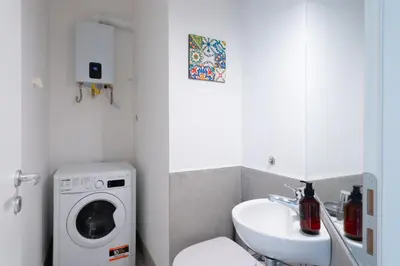 a bathroom with a washing machine and a sink at Dimora Florio in Palermo
