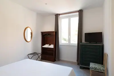 a bedroom with a bed and a tv and a window at Dimora Florio in Palermo