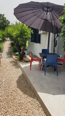 a patio with a table and chairs and an umbrella at Duplex House in Palermo