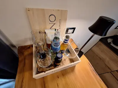 a small table with bottles and glasses on it at Duplex House in Palermo