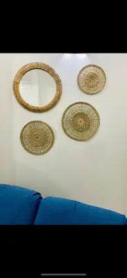 three mirrors on a wall next to a blue couch at Conte125 in Cinisi