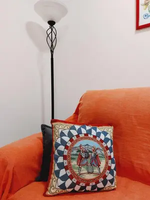 a lamp sitting on top of a couch with a pillow at Un Passo dal Porto in Palermo