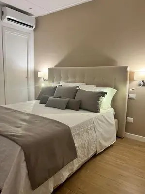a bedroom with a large white bed with pillows at La Casetta delle Strelizie in Palermo