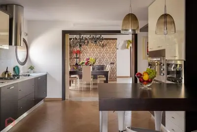 a kitchen with a table with a bowl of fruit on it at Posh villa with pool & jacuzzi in Balestrate