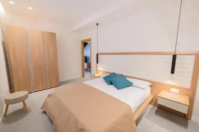 a bedroom with a large bed with a blue pillow at Mondello 2C casa vacanze in Palermo