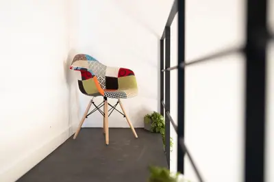 a colorful chair sitting in a room next to a door at Mondello 2C casa vacanze in Palermo
