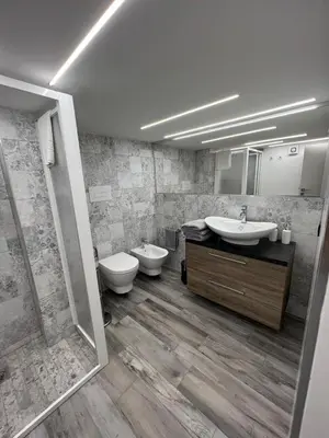 a bathroom with two sinks and a toilet and a shower at Life Rooms in Misilmeri
