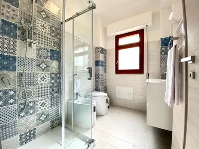 a bathroom with a glass shower and a toilet at Casa Perla Marina sul mare in Castellammare del Golfo