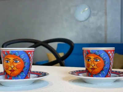 two cups with a face on them on a table at Casa Perla Marina sul mare in Castellammare del Golfo