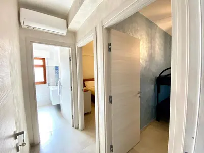 a hallway with a door leading to a bedroom at Casa Perla Marina sul mare in Castellammare del Golfo