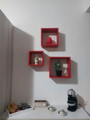 a kitchen with three pictures on the wall and a counter at Kalisa Home, B&B e Casa Vacanza Palermo in Capaci