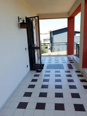 an open door of a house with a checkered floor at Casa vacanze zina in Altavilla Milicia