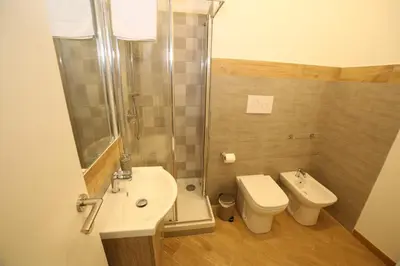 a bathroom with a sink and a toilet and a shower at Thalia in Palermo