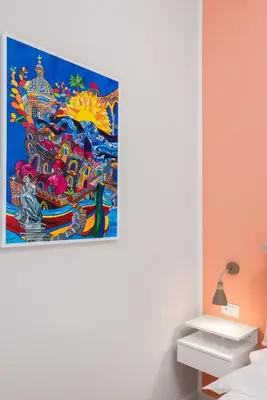 a painting hanging on a wall in a room at LE PORTE DEL KASSARO in Palermo