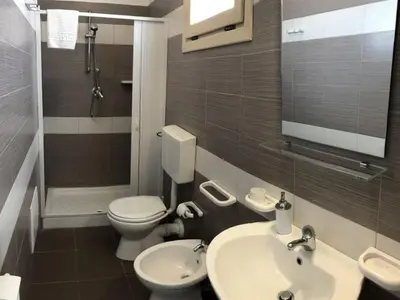a bathroom with a toilet and a sink and a shower at Villa MiraScopello in Castellammare del Golfo