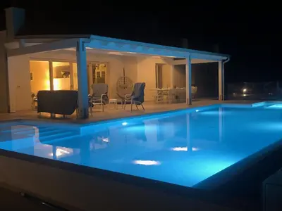 a swimming pool at night with a gazebo at Villa MiraScopello in Castellammare del Golfo