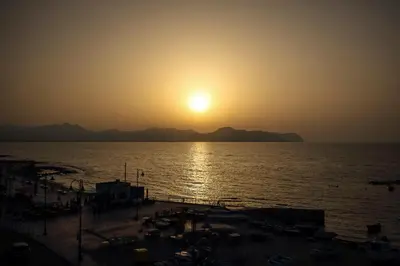 a sunset over a body of water with a beach at La casa di Jack in Bagheria
