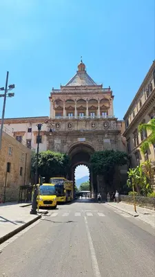 a building with an arch in the middle of a street at La Porta dei Mori in Palermo