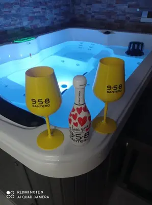a hot tub with two yellow chairs and a bottle at Golden House con jacuzzi in Castellammare del Golfo