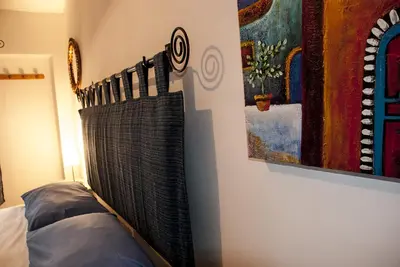 a bedroom with a bed and a painting on the wall at Bed And Breakfast Maria in Scopello