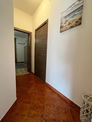 a hallway with a door and a tile floor at Casa Vacanza Randazzo in Trappeto