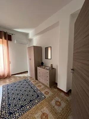 an empty room with a dresser and a bedroom at Casa Vacanza Randazzo in Trappeto