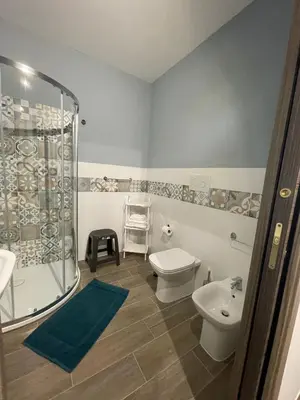 a bathroom with a shower and a toilet and a sink at La Casa Dei Cavalieri in Caccamo