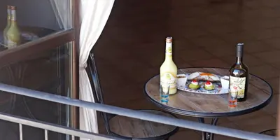a table with two bottles of wine and a plate of food at La Casa di Filippo in Palermo