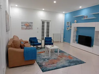 a living room with a couch and a tv at Kalsa Casa dei Mori in Palermo