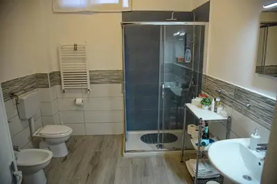 a bathroom with a shower and a toilet and a sink at Kalsa Casa dei Mori in Palermo