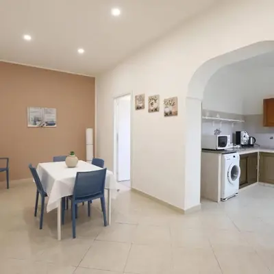a kitchen and dining room with a table and chairs at Kalsa Casa dei Mori in Palermo