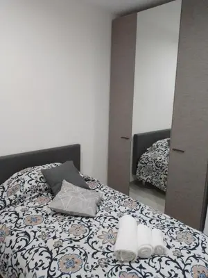 a bedroom with a bed and a mirror at Holiday House Lady in Terrasini