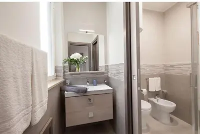 a bathroom with a sink and a toilet and a mirror at Holiday House Lady in Terrasini