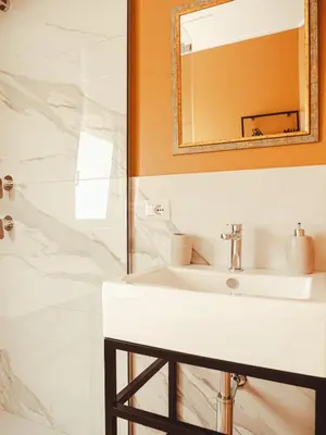 a bathroom with a white sink and a mirror at U Zuccareddu in Alcamo