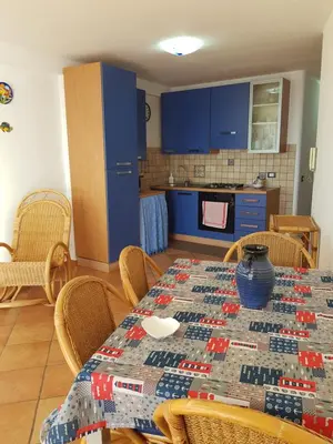 a kitchen with a table with a quilt on it at Calipso in Bagheria