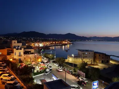 a view of a city with a harbor at night at Calipso in Bagheria