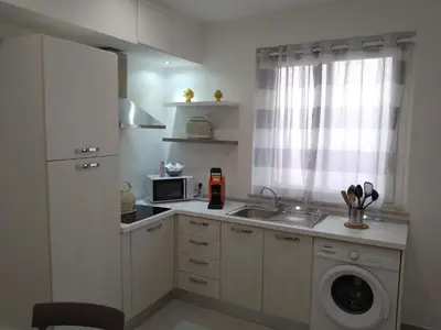 a kitchen with a sink and a washing machine at Holiday House Monalisa in Terrasini