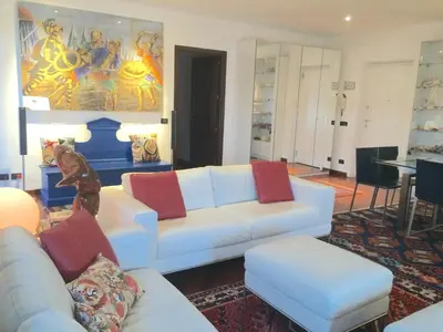 a living room with a white couch and red pillows at Mondello Luxury Apartment on the Beach in Mondello