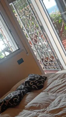a bed in a room with a large window at Nido del falco in Mondello