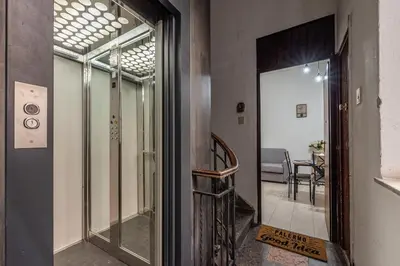 a hallway with a glass door leading to a dining room at I Mori-holiday apartment in Palermo